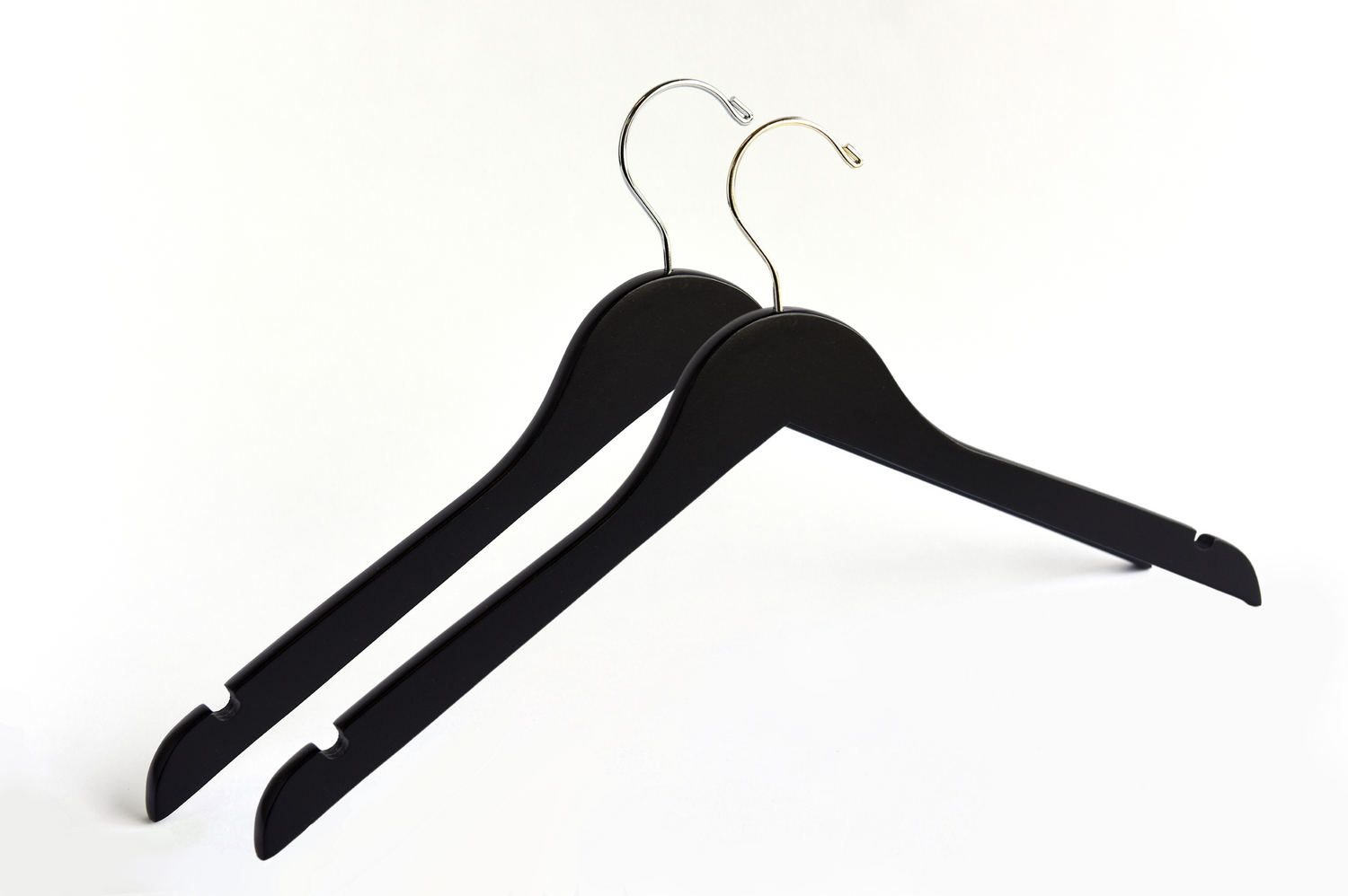 Two Matte Black Wooden Adult Clothes Hangers with a gold hook and a silver hook for residential closets and retail stores