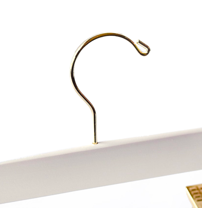 Top of a high quality Ivory Off-White Wooden Bottom Hanger for adults with a gold hook facing to the right