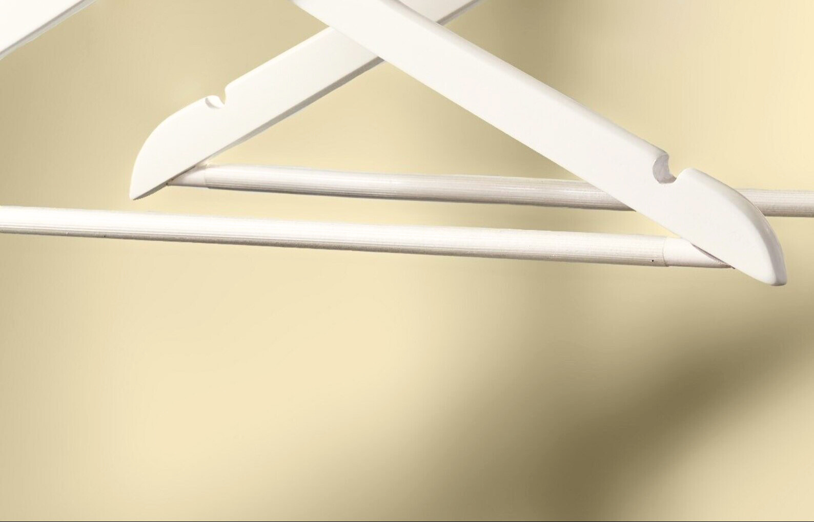 Ivory Wooden Flat Suit Hangers’ non-slip wood pant bars with plastic grooved sleeves designed to hold clothes in place