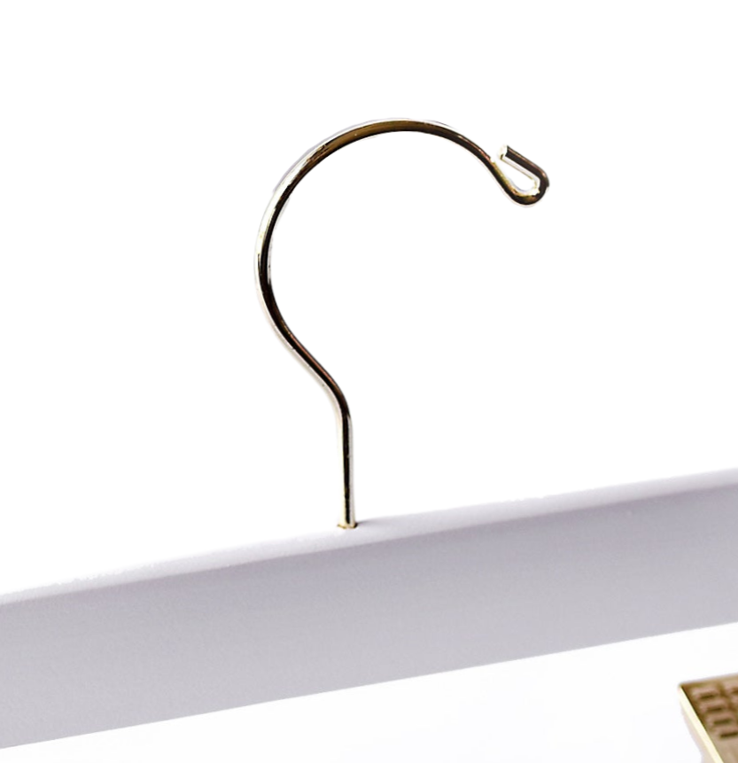 Top of a high quality Stark White Wooden Bottom Hanger for adults with a gold hook facing to the right