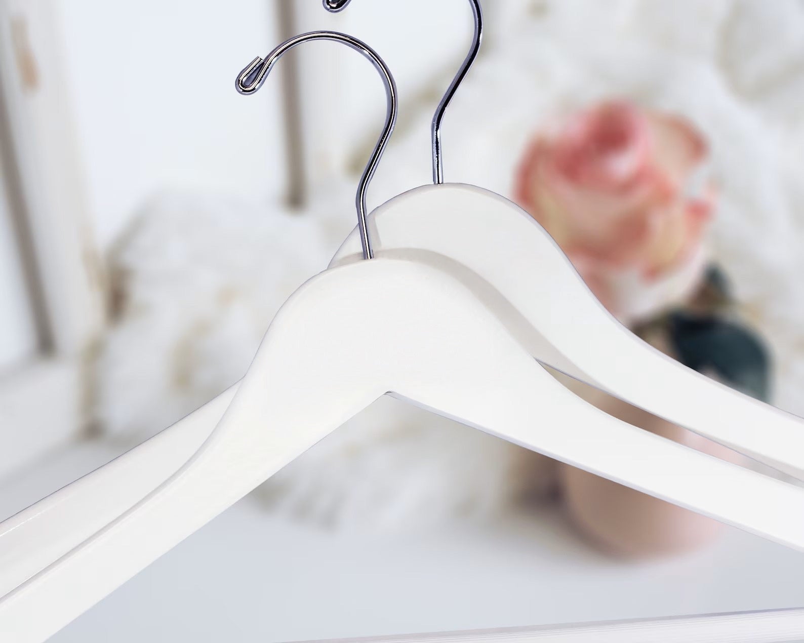 Two White Wooden Suit Hangers with silver hooks for custom bridal hanger designers, home closets, and retail stores