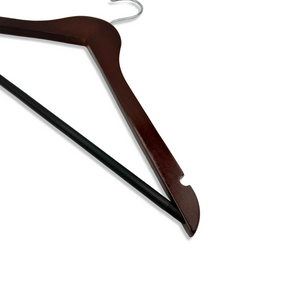 The arm of a Dark Walnut Wooden Suit Hanger with shoulder notches and a non-slip pants bar for closets and stores