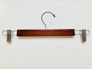 Light Walnut Wooden Bottom Hanger with a silver, adjustable side cushion clips for residential closets and retail stores