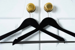 Load image into Gallery viewer, Two Matte Black Wooden Suit Hangers with pants bar for custom wedding hanger designers hanging on closet door’s doorknob #hook-color_silver-hook
