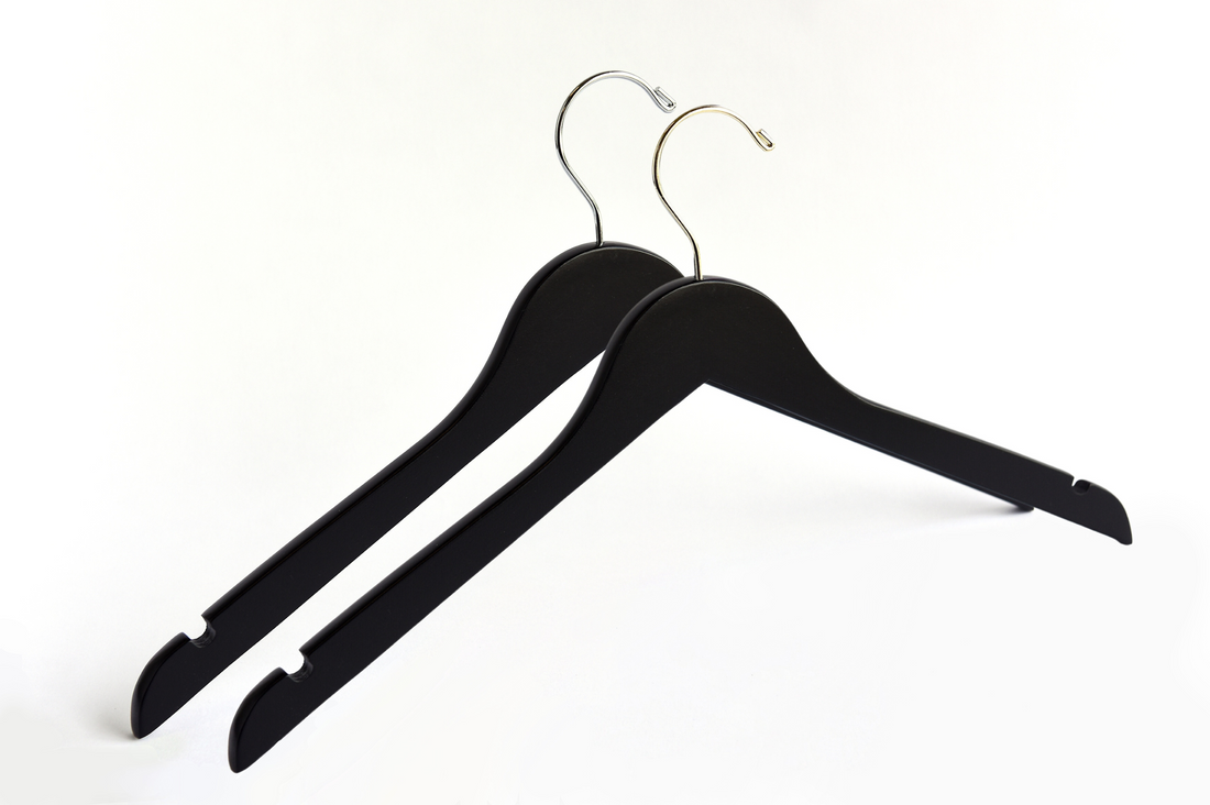 Two Matte Black Wooden Adult Clothes Hangers with a gold hook and a silver hook for residential closets and retail stores