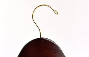 Top of Dark Walnut Wooden Clothes Hanger with a gold hook facing to the right #hook-color_gold-hook