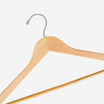 Load image into Gallery viewer, A close up of a Natural Wooden Suit Hanger with a silver hook and non-slip pants bar for custom wedding hanger designers
