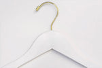 Load image into Gallery viewer, Top of White Wood Clothes Hanger with a gold hook for residential closets and retail spaces #hook-color_gold-hook
