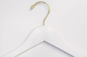 Top of White Wood Clothes Hanger with a gold hook for residential closets and retail spaces #hook-color_gold-hook